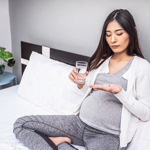 pregnant woman taking vitamins